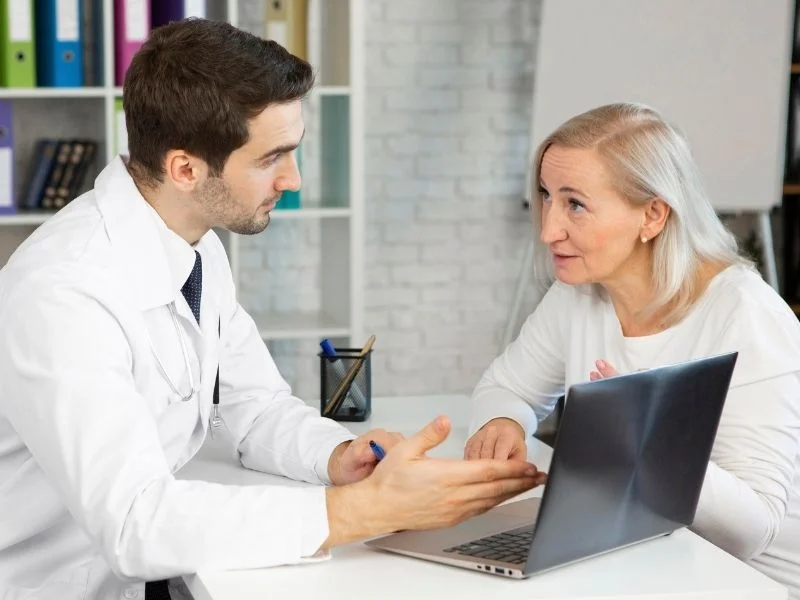 Doctor discussing next steps with a patient at a desk