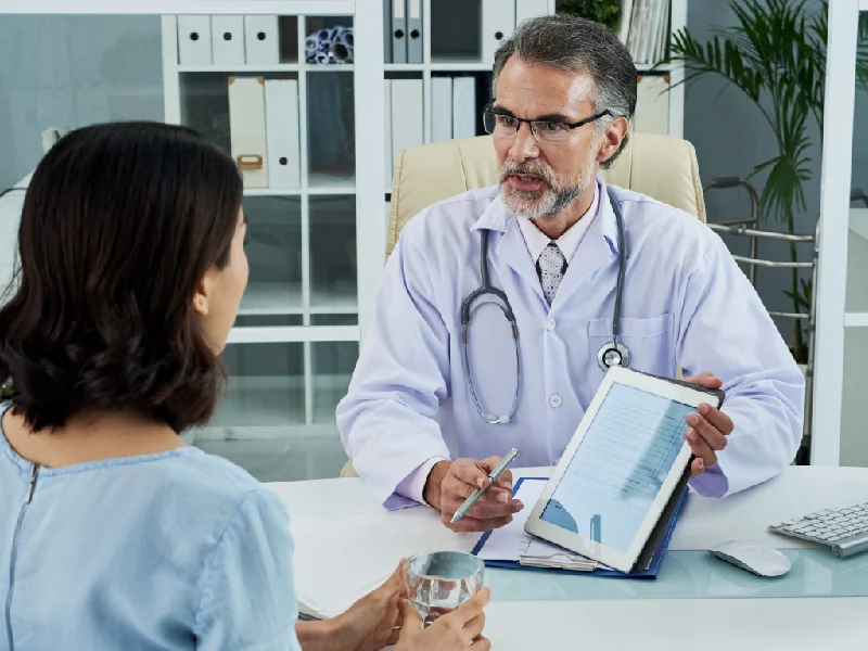 Clinician reviewing a patient's treatment plan on a tablet