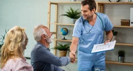 Nurse greeting an older couple during a clinic visit